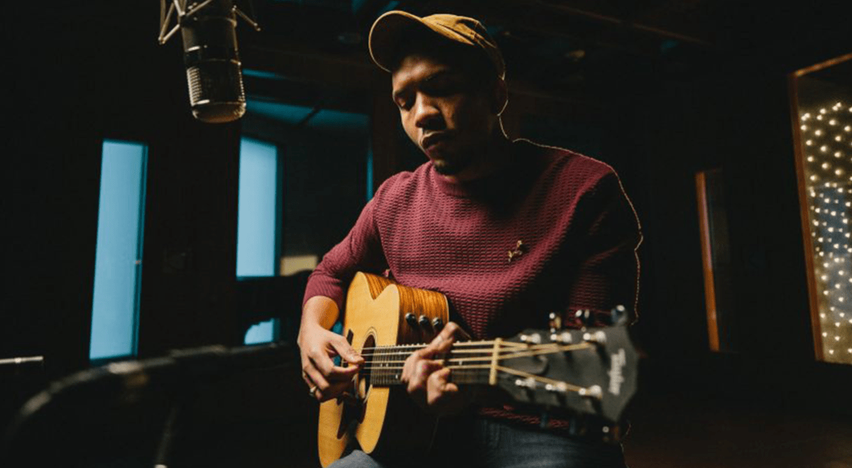 Juke Ross, an up and coming musician from Kygo's Palm Tree Records label, sitting down and playing the guitar.